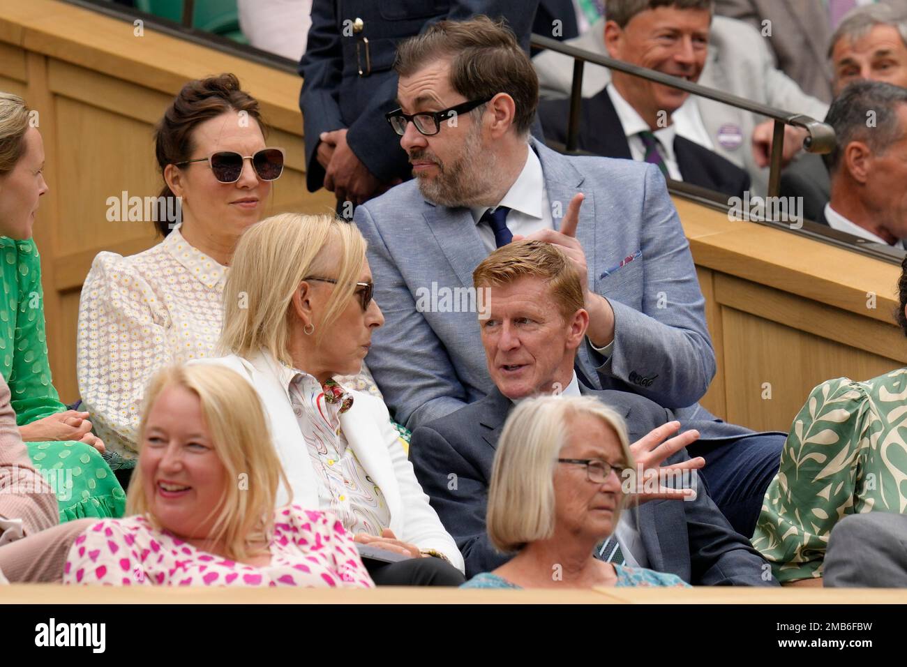 Tennis great Martina Navratilova, center left, and British astronaut Tim Peake, center right, take their seats to watch a first round singles match on day one of the Wimbledon tennis championships in