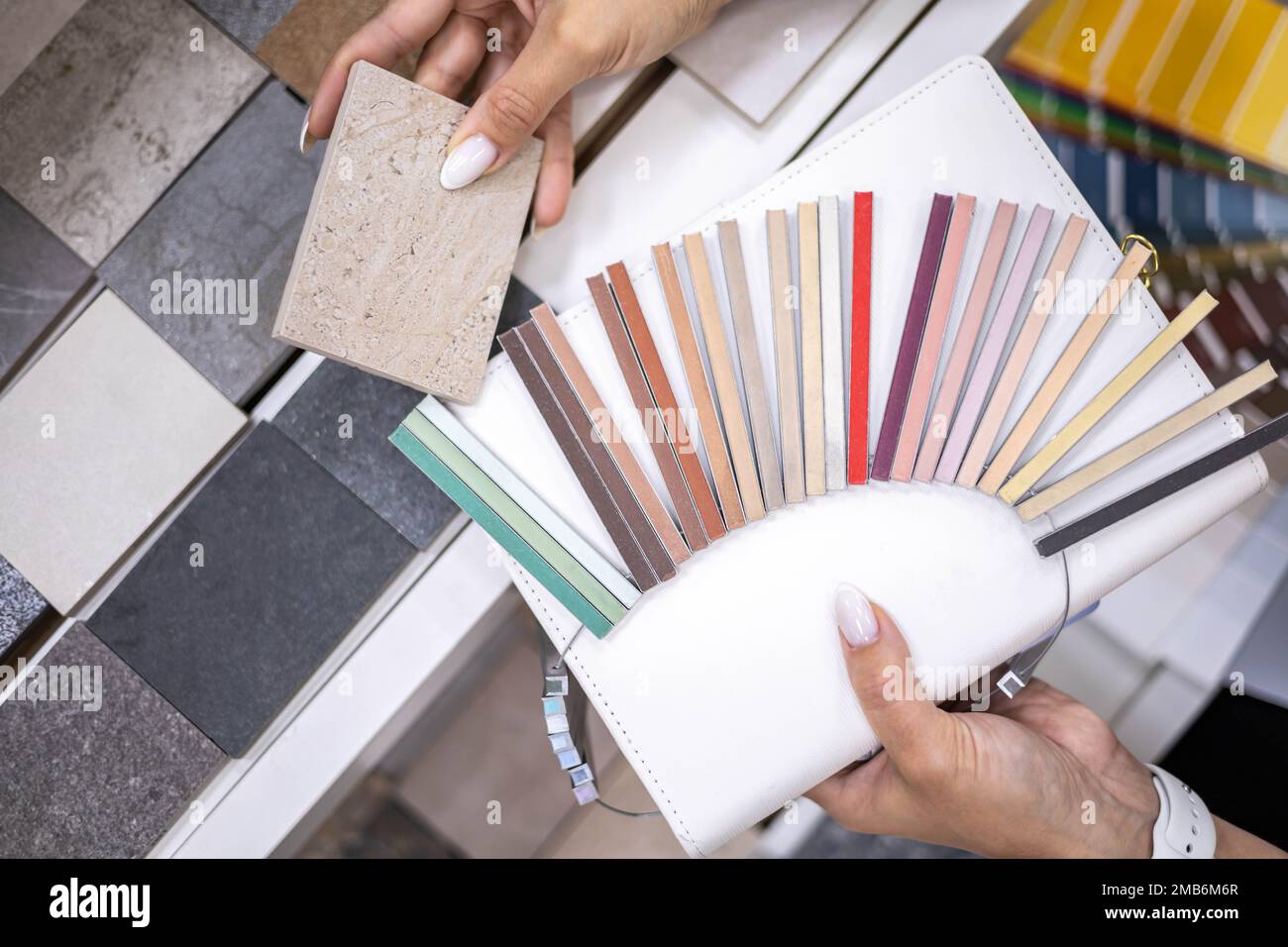 Woman architect designer select epoxy grout ceramic tiles compare