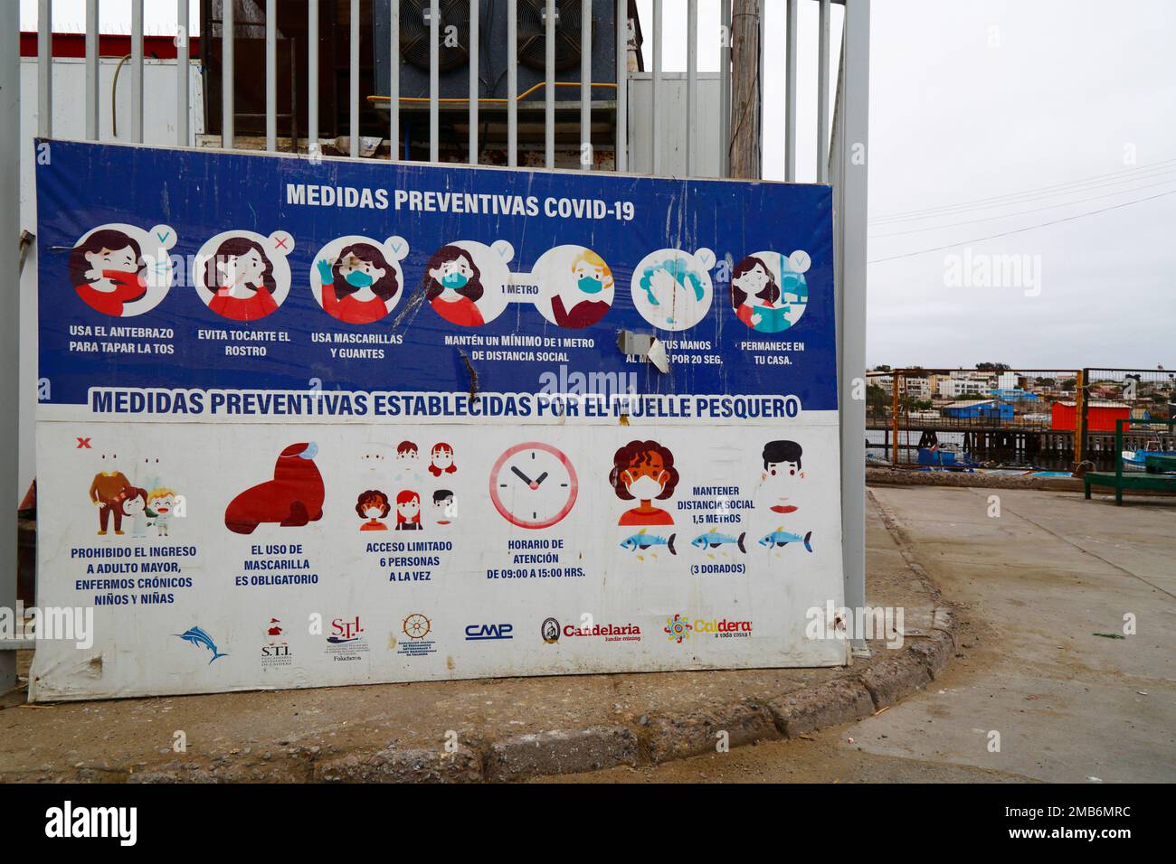 Detail of sign with recommendations to prevent the spread of the covid-19 coronavirus at entrance to fishing port and docks, Caldera, Region III; Chile. Stock Photo