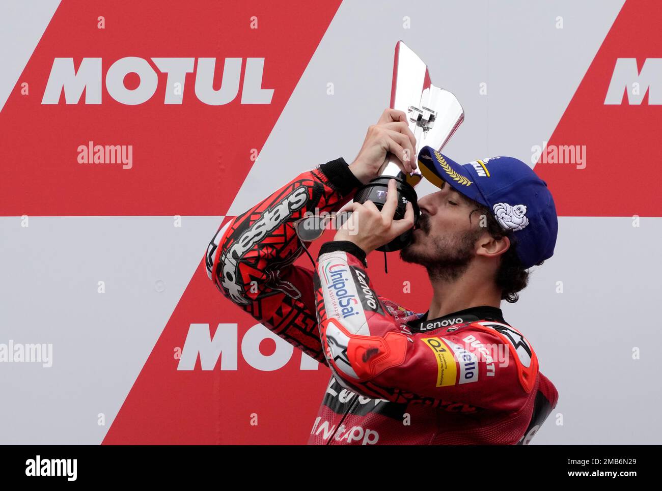 Italian rider Francesco Bagnaia of the Ducati Lenovo Team celebrates with trophy on the podium after winning the MotoGP race at the Dutch Grand Prix in Assen, northern Netherlands, Sunday, June 26,