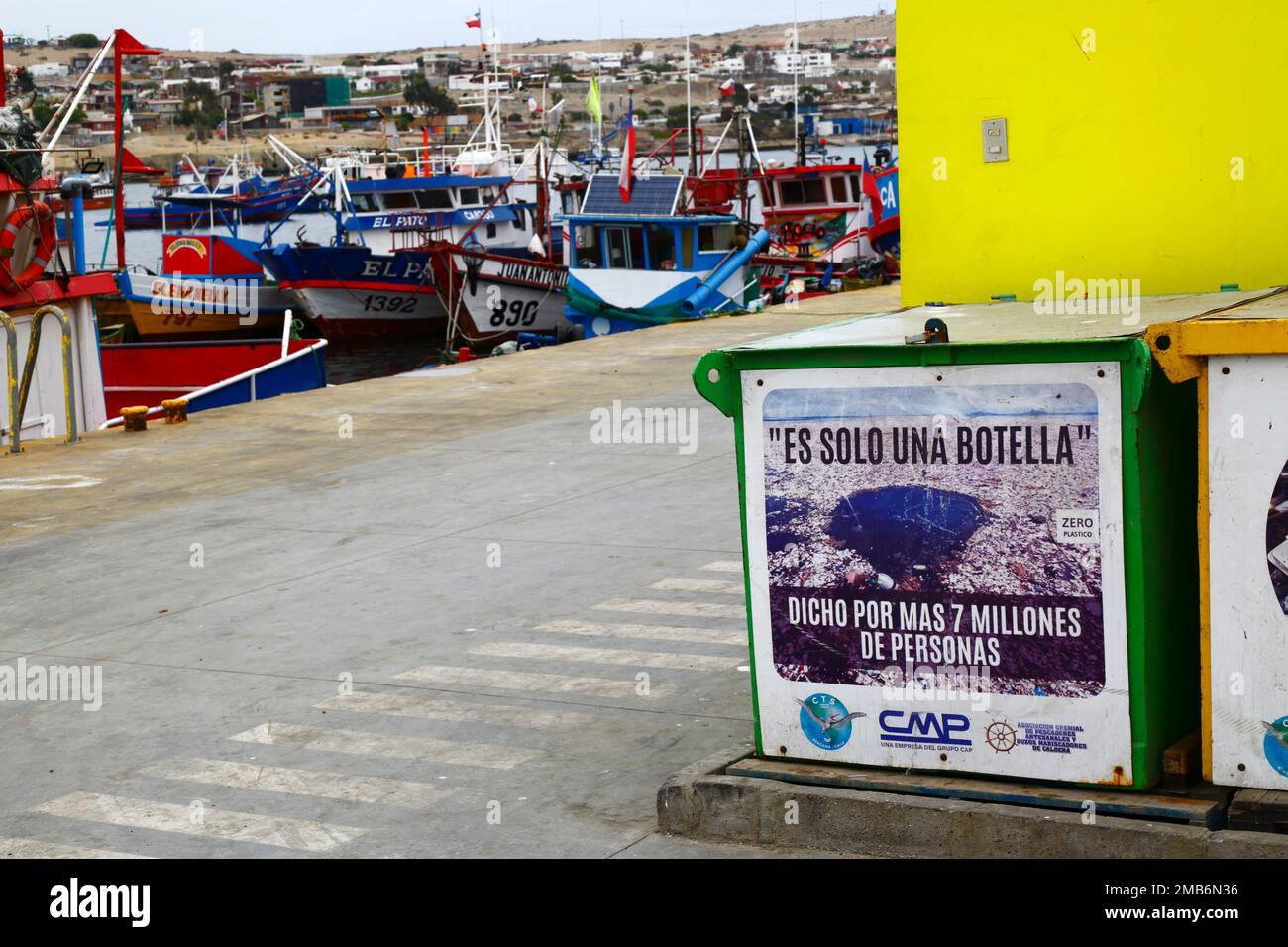 Sign in fishing docks encouraging people and fishermen not to throw plastic bottles into the sea, Caldera, Chile. The Spanish translates as 'It's only one bottle, said more than 7 million people'. Stock Photo