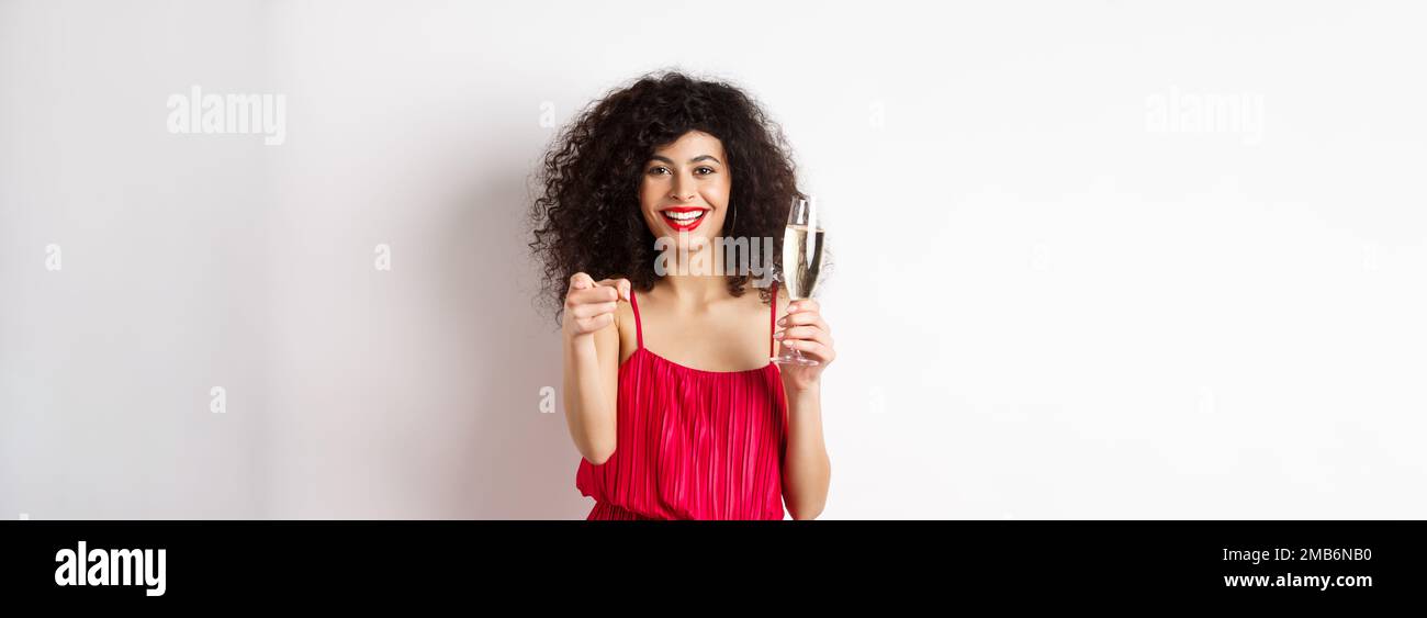 Beautiful curly woman in red dress, partying or having romantic date