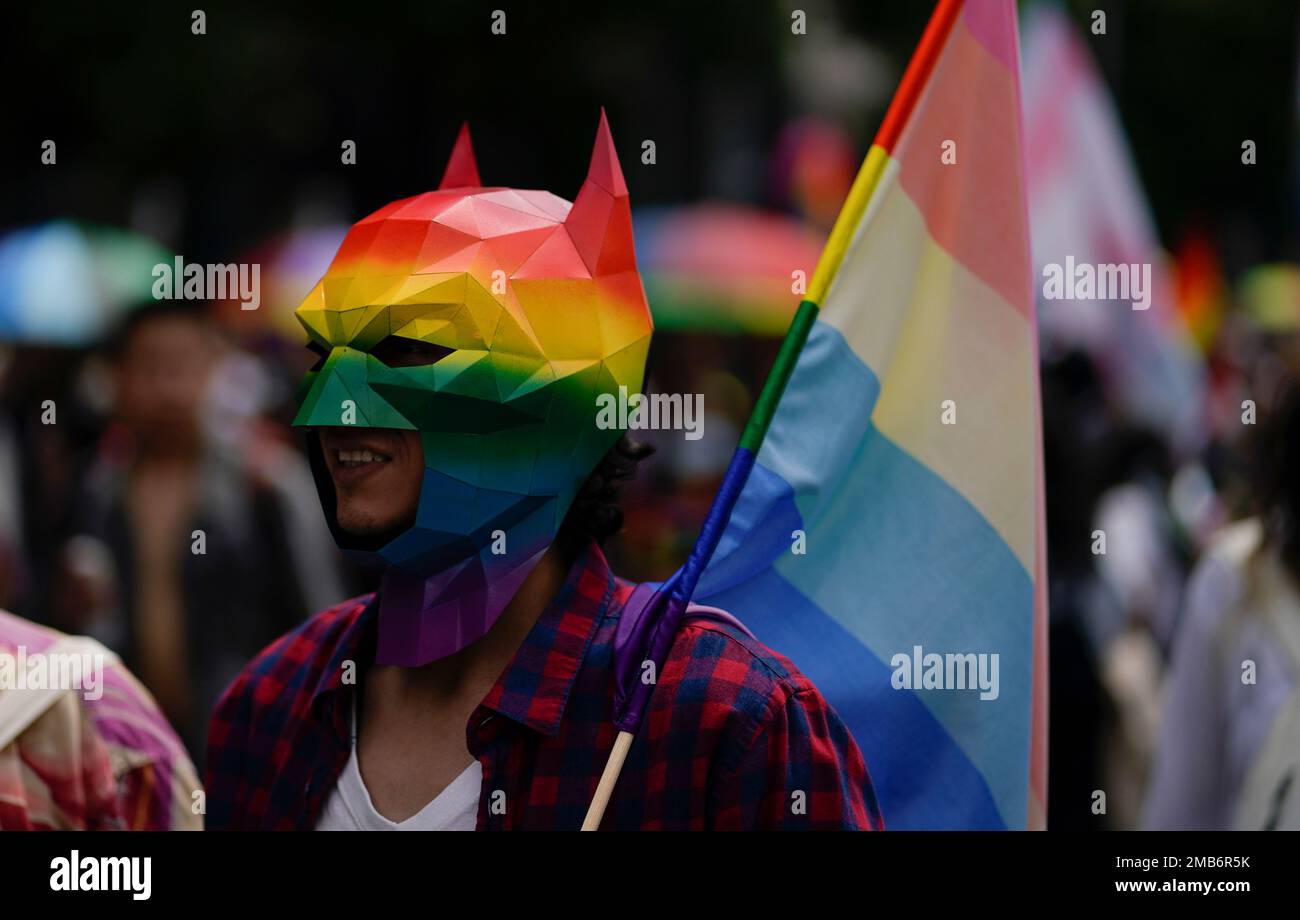 A participant wearing a Batman mask in a rainbow motif takes part in the  annual Pride march in Mexico City, Saturday, June 25, 2022. (AP  Photo/Eduardo Verdugo Stock Photo - Alamy