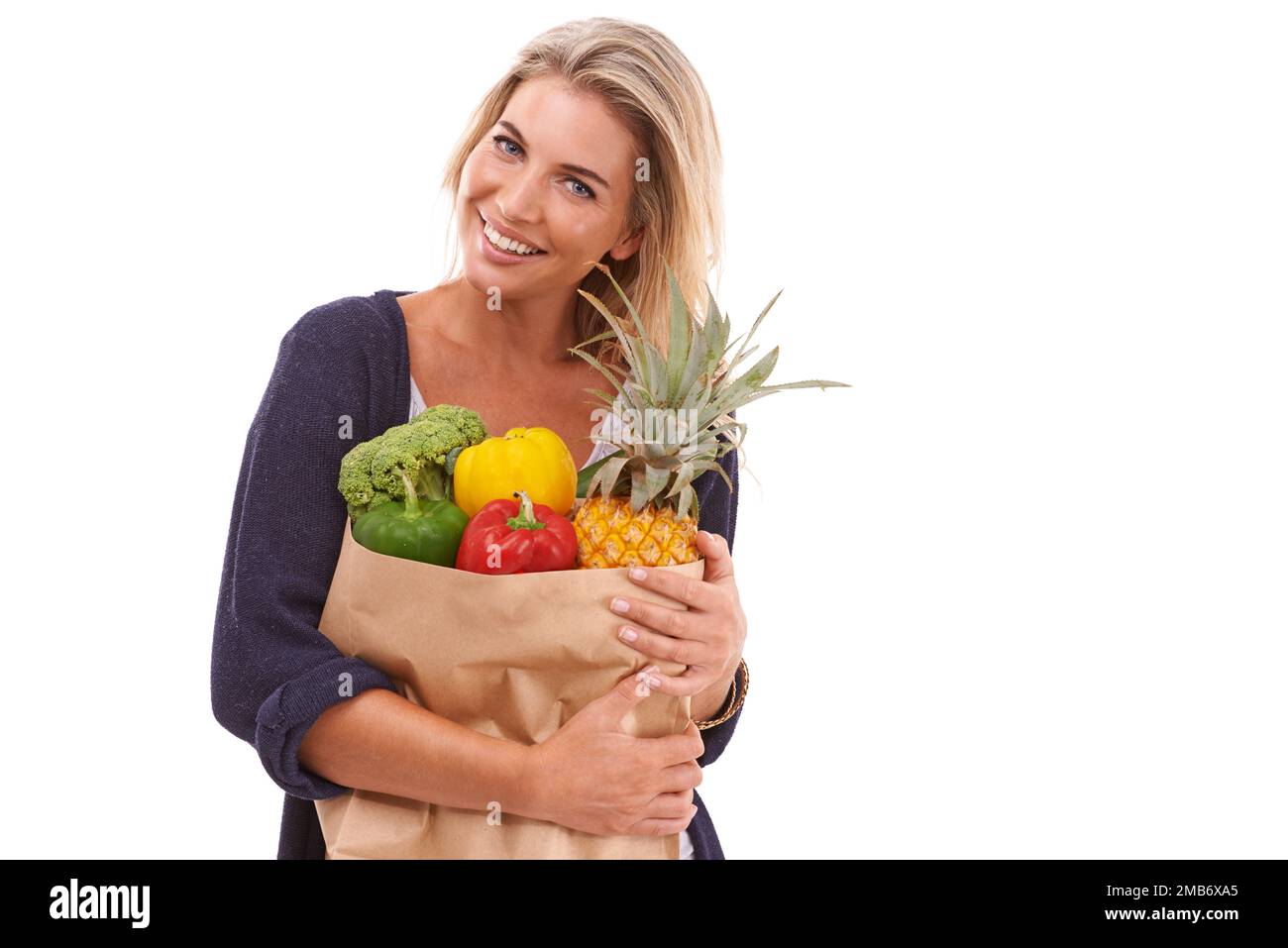 Shopping, portrait or happy woman with vegetables, fruit or healthy food in studio on white background. Diet, smile or happy customer with fruits Stock Photo