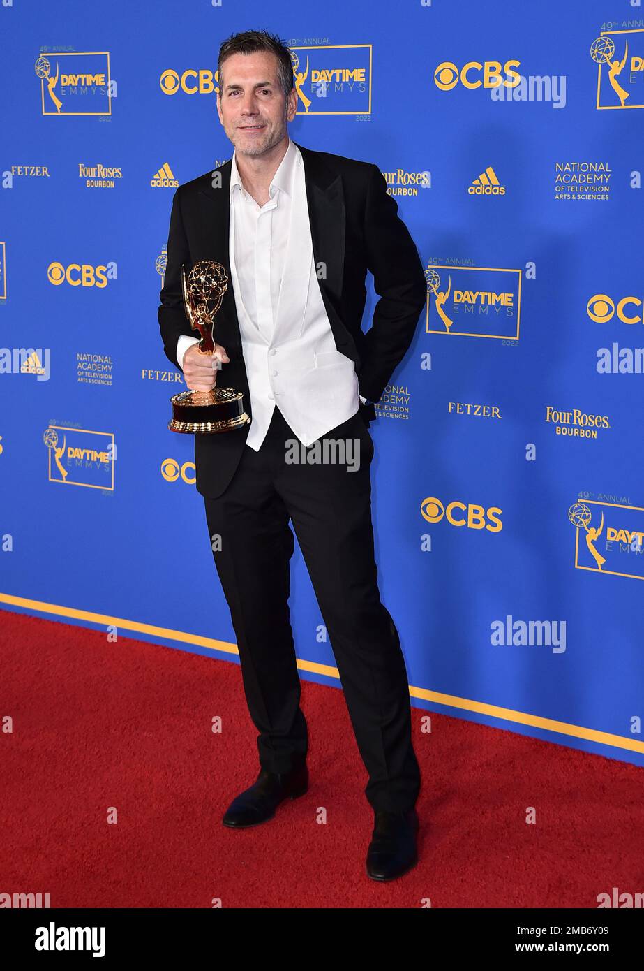 Frank Valentini poses in the press room with the award for outstanding