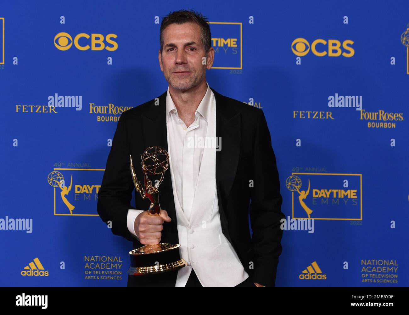 Frank Valentini poses in the press room with the award for outstanding