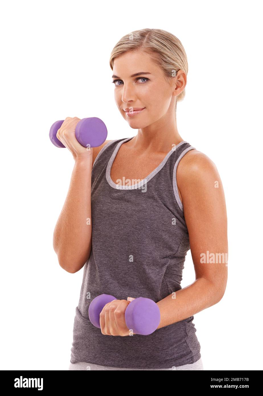 Woman, dumbbells and studio portrait for wellness, muscle development and health by white background. Weightlifting model, vision and isolated for Stock Photo