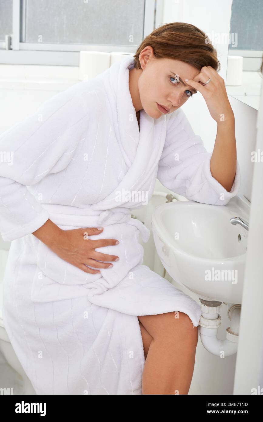 Worried woman in bathroom stomach hires stock photography and images