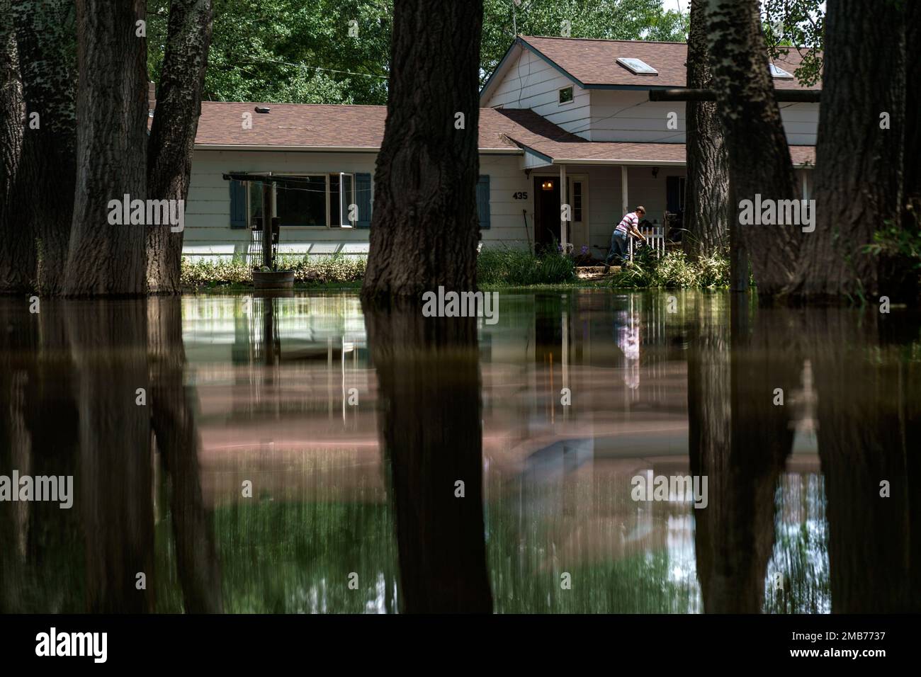 Aileen Rogers helps clean out a friend's house badly damaged by the