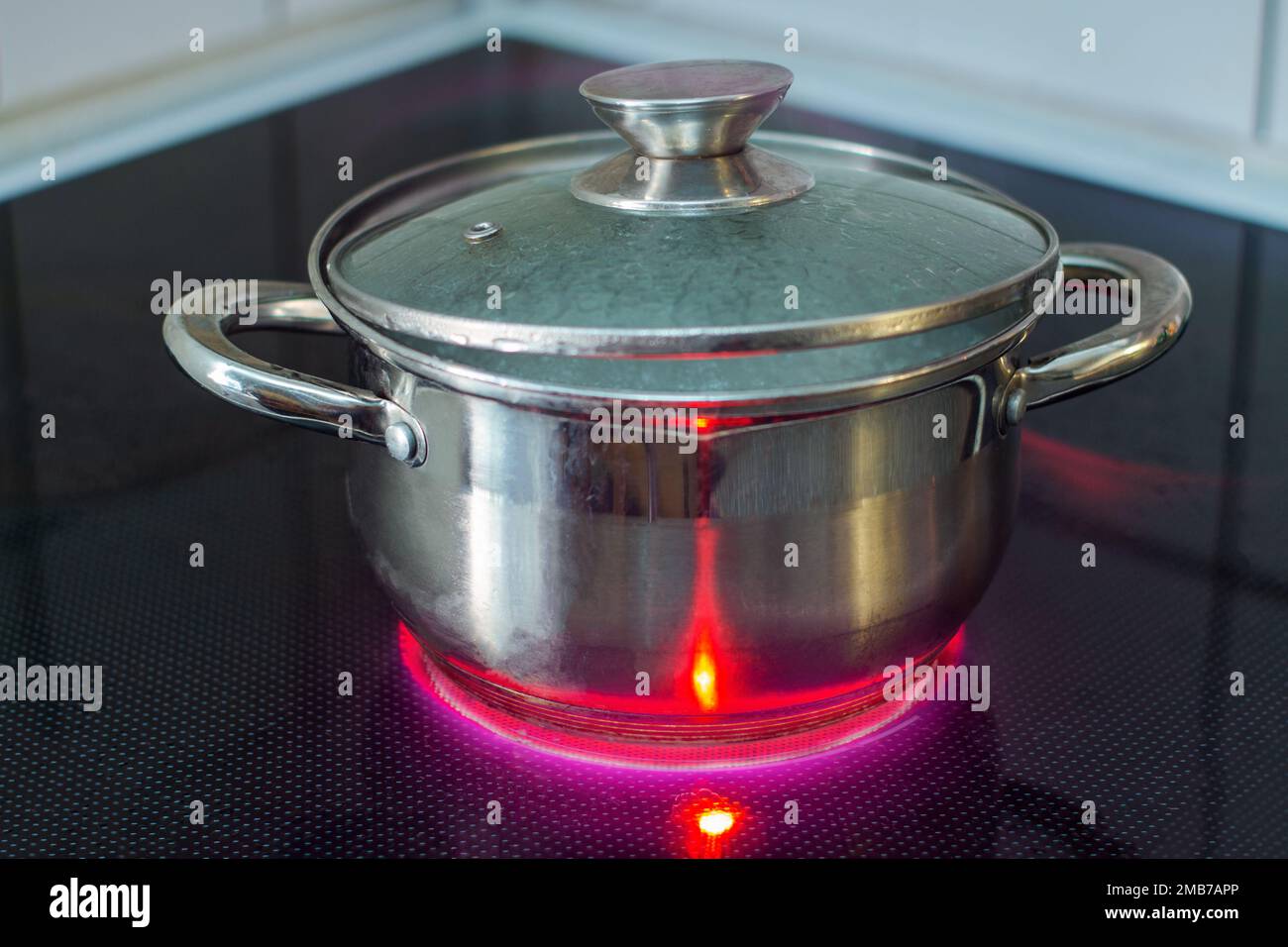 Heating a pot on electric stove using electricity Stock Photo Alamy