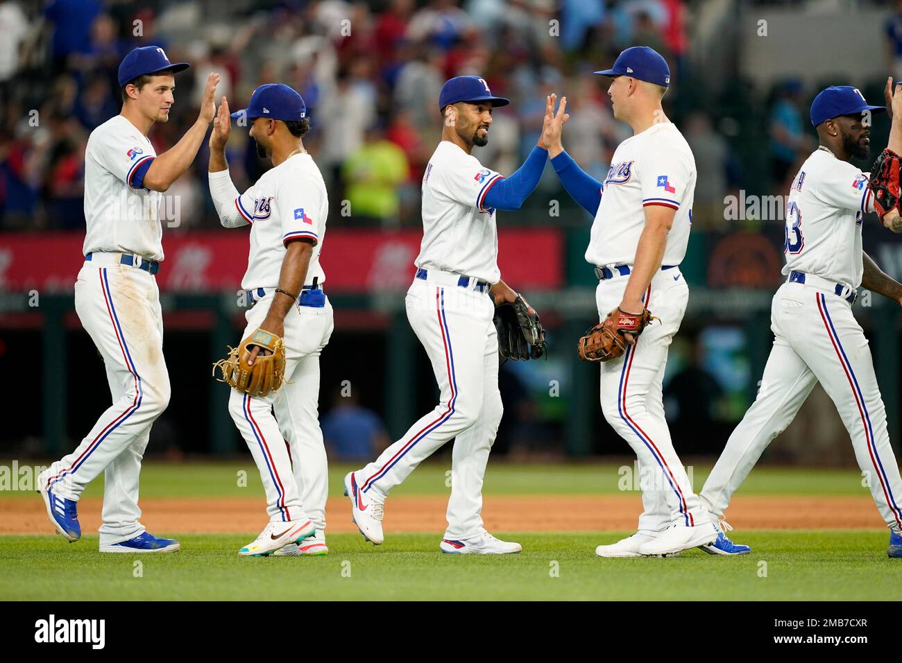 Texas Rangers' Corey Seager, Ezequiel Duran, Marcus Semien, Nathaniel Lowe  and Adolis Garcia, from left, celebrate the team's 4-2 win in a baseball  game against the Philadelphia Phillies, Wednesday, June 22, 2022
