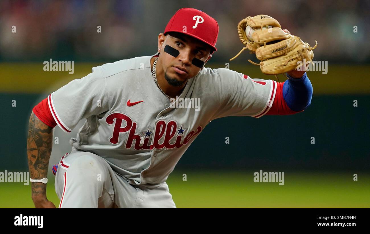 Philadelphia Phillies third baseman Johan Camargo holds his glove out after  catching a line out by Texas Rangers' Adolis Garcia in the fourth inning of  a baseball game, Tuesday, June 21, 2022