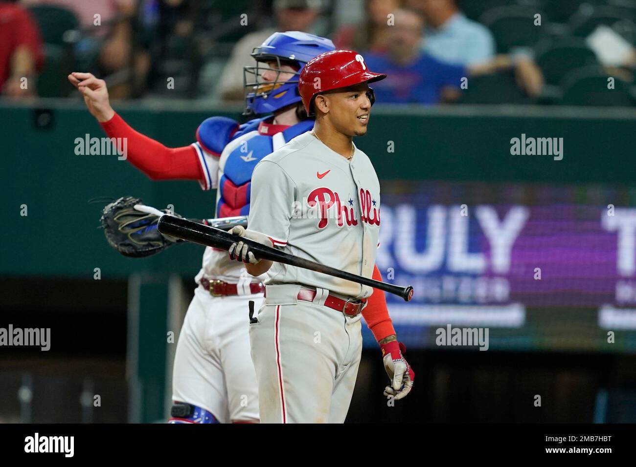 Philadelphia Phillies' Yairo Munoz looks back at the umpire after being  called out on a dead ball strike out in the seventh inning of a baseball  game as Texas Rangers catcher Jonah