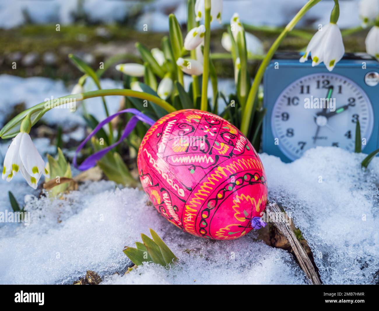 Easter eggs lie in the snow Stock Photo