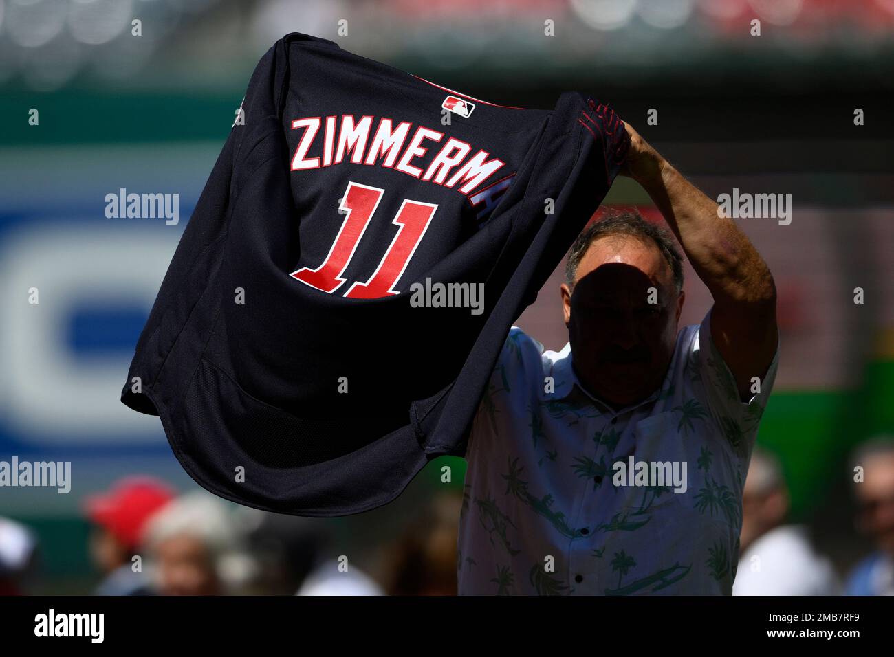 Keith Zimmerman, father of former Washington Nationals baseball player Ryan  Zimmerman, holds up Ryan's jersey at a jersey retirement ceremony before a  baseball game between the Nationals and the Philadelphia Phillies, Saturday