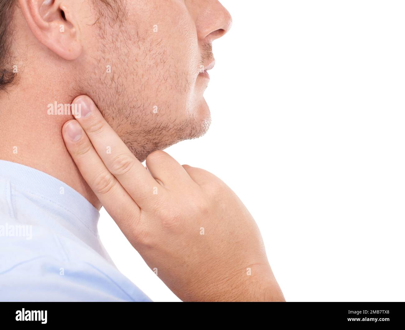 Checking on his pulse. Young man taking his heart rate against a white