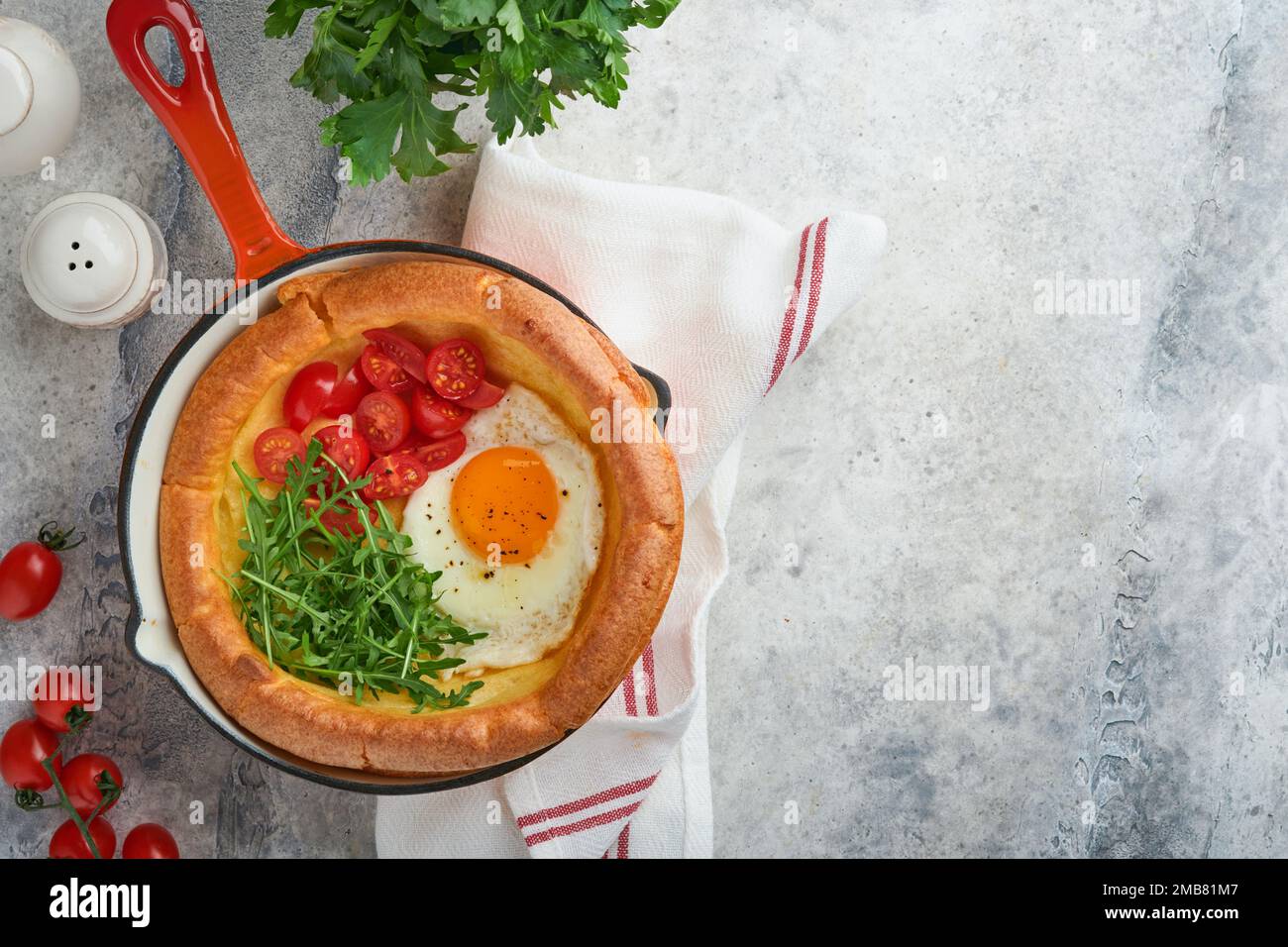 Fried Reeds Dutch baby pancake. Fresh homemade Dutch Baby pancake with fried egg ...