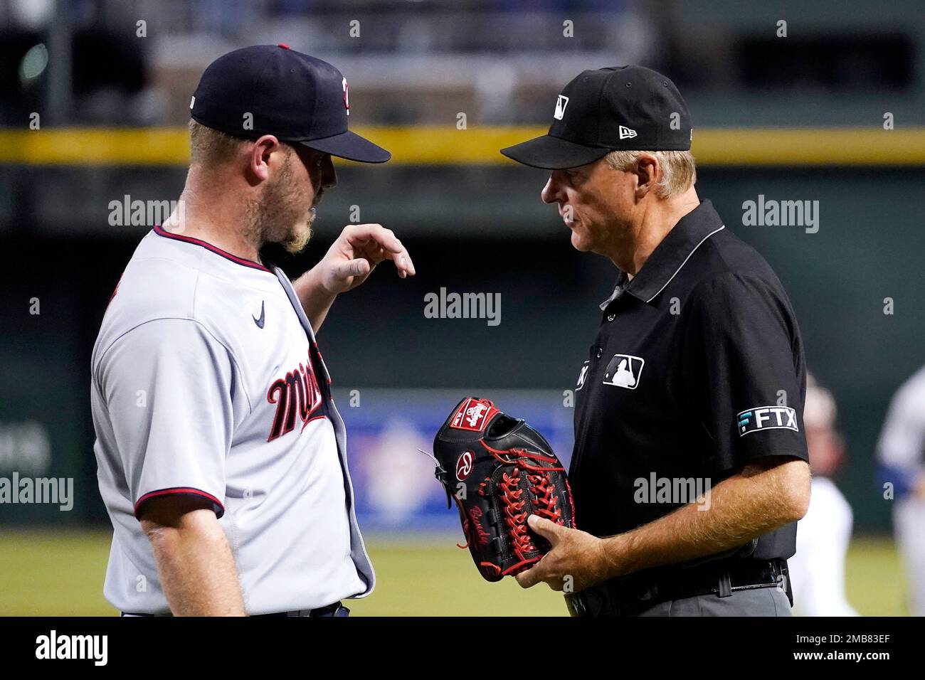 Minnesota Twins starting pitcher Dylan Bundy, left, has his glove examined  by umpire Ed Hickox during the first inning of the team's baseball game  against the Arizona Diamondbacks on Saturday, June 18,