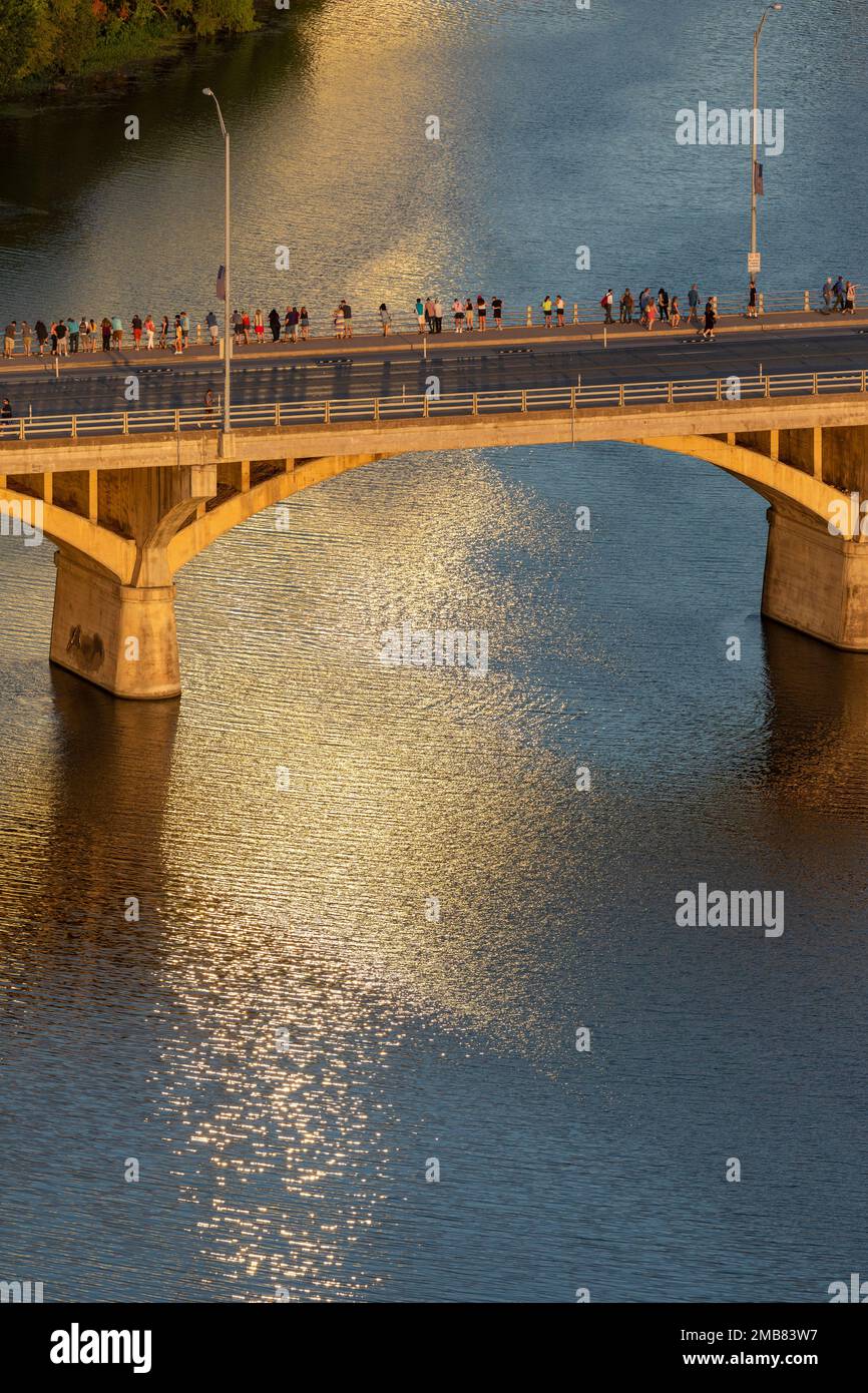 Tourists gather near sunset on Ann W. Richards Congress Street Bridge that crosses Ladybird Lake