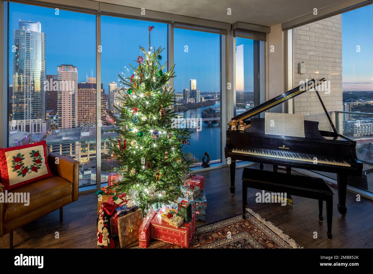 Decorated Christmas tree with evening Austin, Texas skyline view from