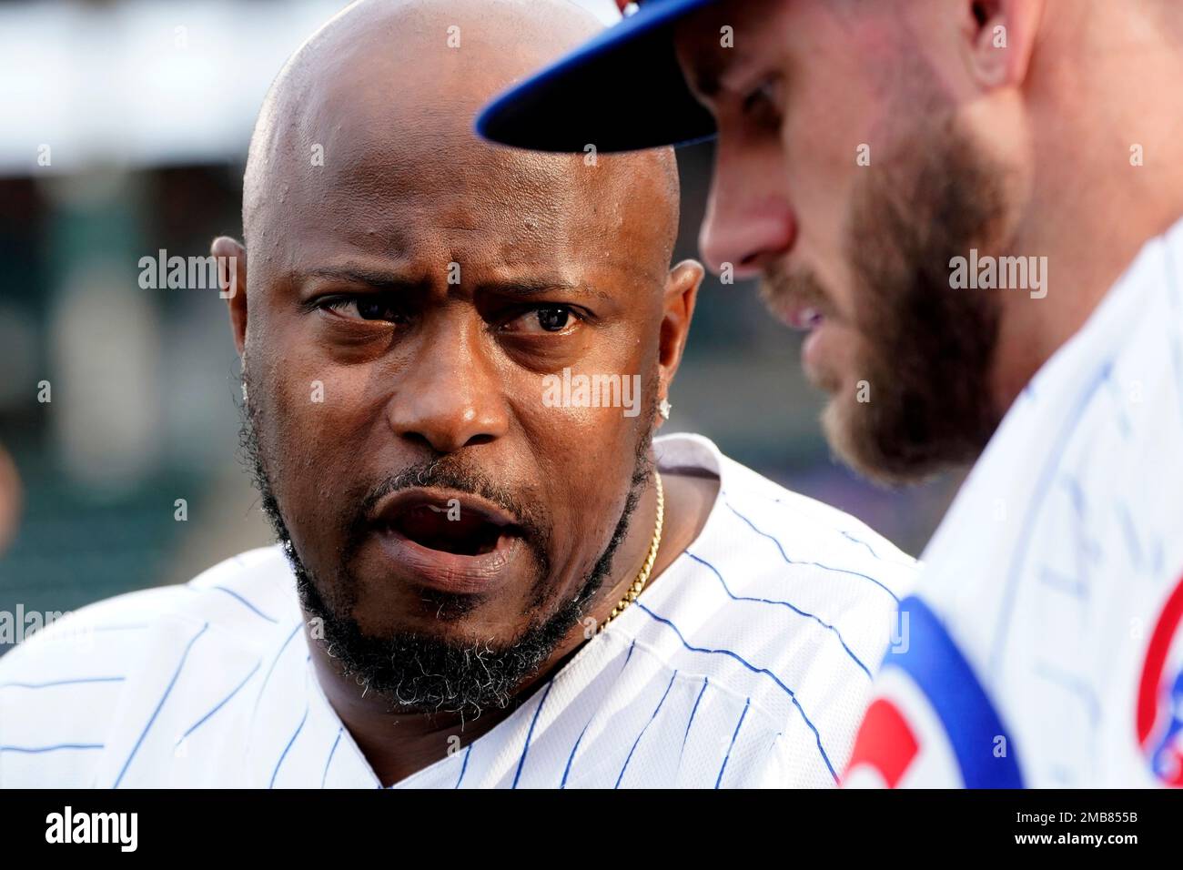 Chicago Cubs third base coach Willie Harris talks to Patrick Wisdom in the  dugout before a baseball game against the San Diego Padres Wednesday, June  15, 2022, in Chicago. (AP Photo/Charles Rex