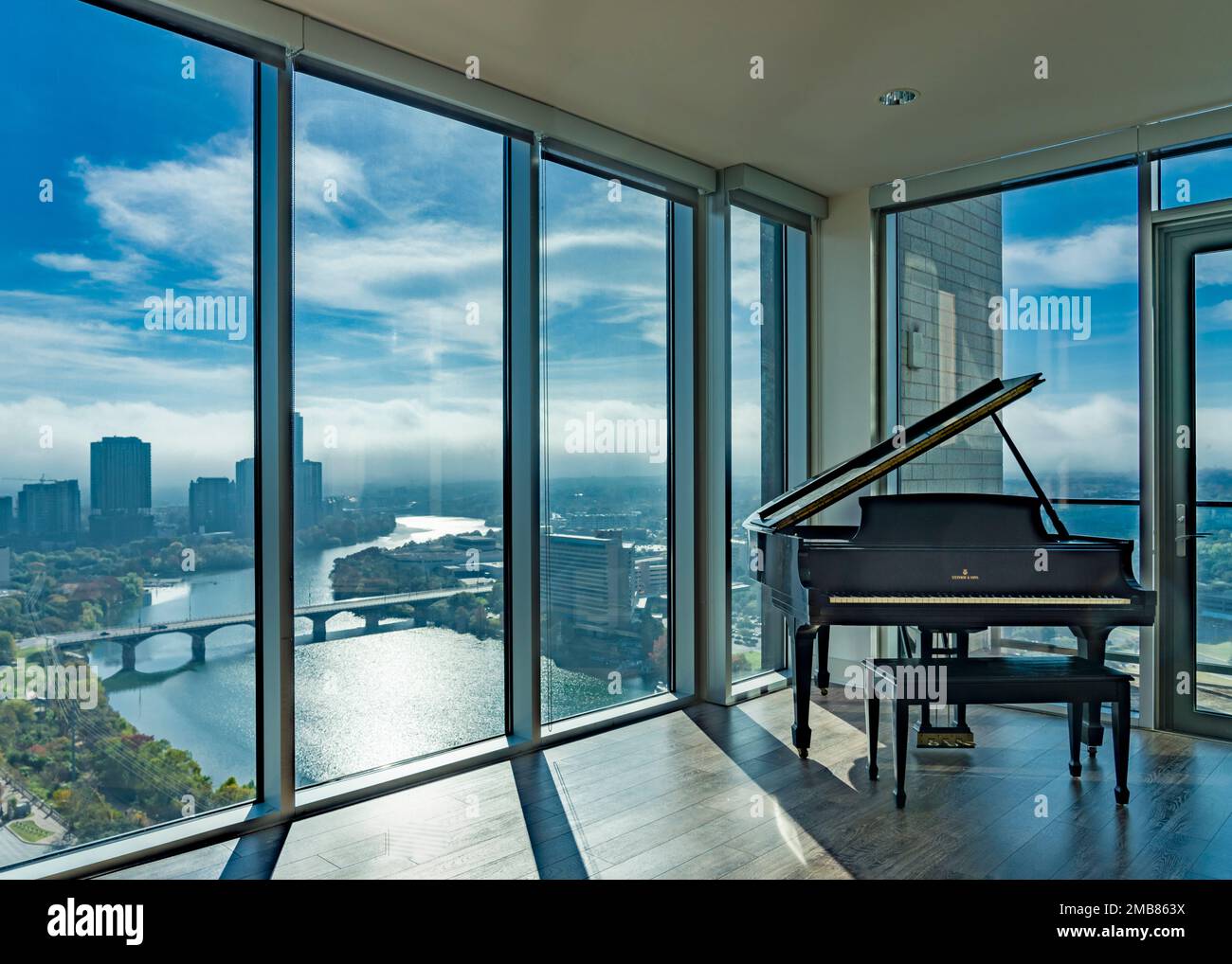 View of Grand Piano in luxury apartment overlooking Austin, TX skyine with ...