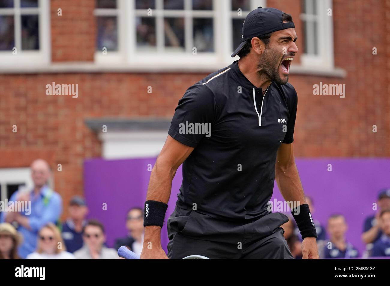 Italys Matteo Berrettini celebrates after beating Botic van de Zandschlup of the Netherlands in a semifinal tennis match at the Queens Club Championships in London, Saturday, June 18, 2022