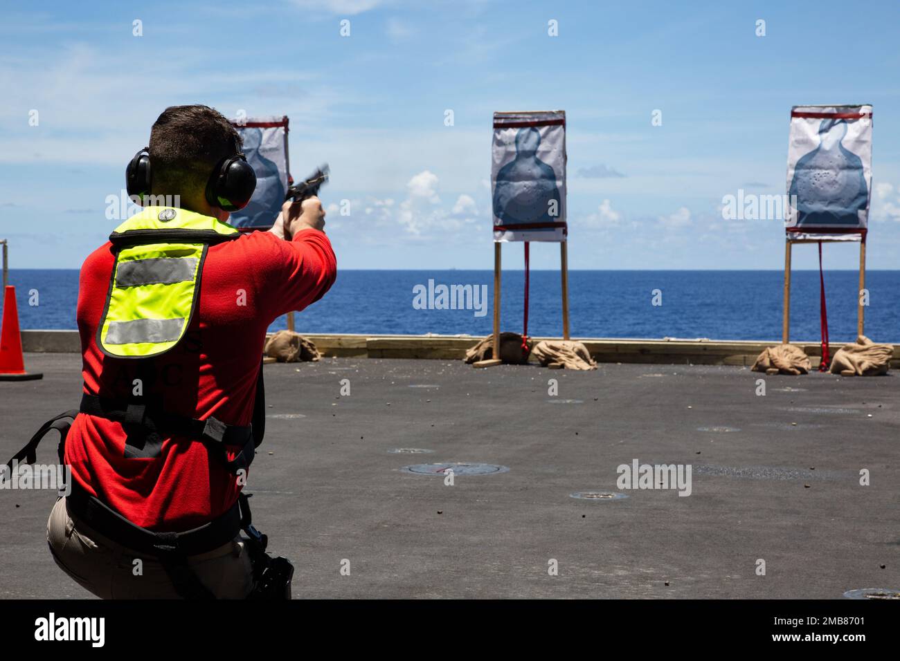 PHILIPPINE SEA (June 13, 2022) Chief Aviation Ordnanceman Ryan Heeney, from Portland, Ore., shoots an M9 service pistol during a live-fire exercise aboard the Nimitz-class aircraft carrier USS Abraham Lincoln (CVN 72). Abraham Lincoln Strike Group is on a scheduled deployment in the U.S. 7th Fleet area of operations to enhance interoperability through alliances and partnerships while serving as a ready-response force in support of a free and open Indo-Pacific region. Stock Photo