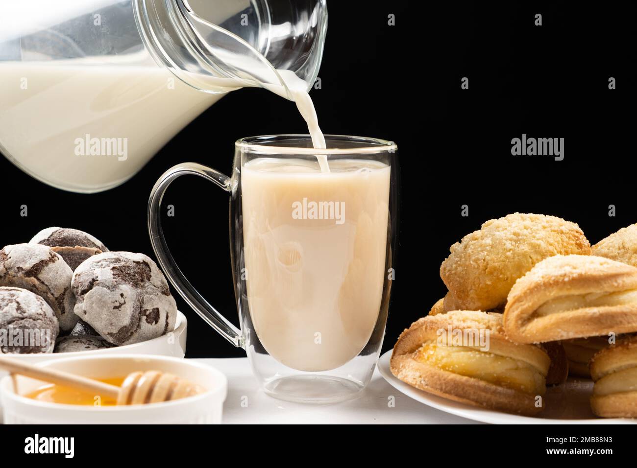 Making milk tea milk from a glass jug is poured into black English