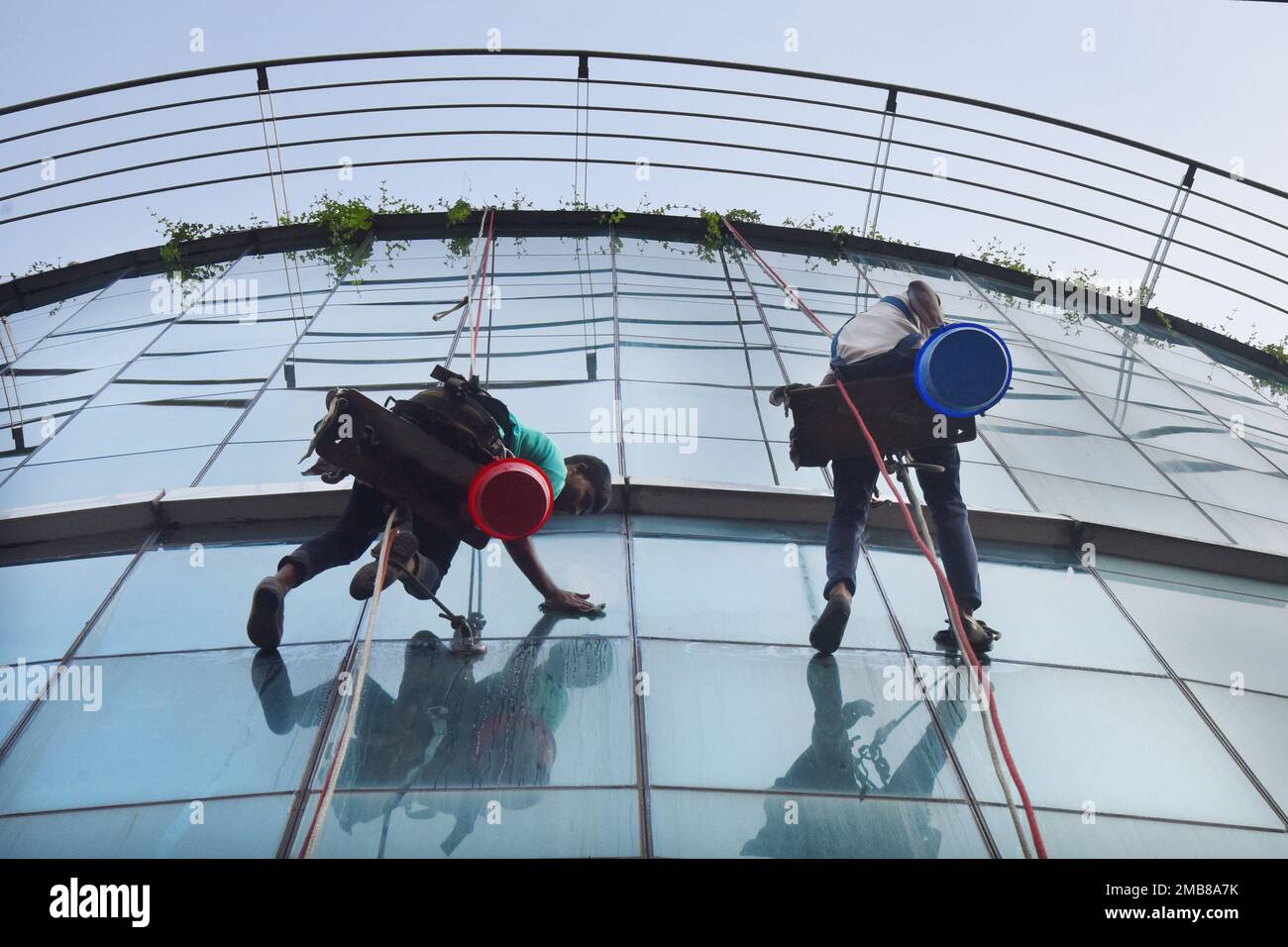Workers glass cline a highrise building on a construction site area in