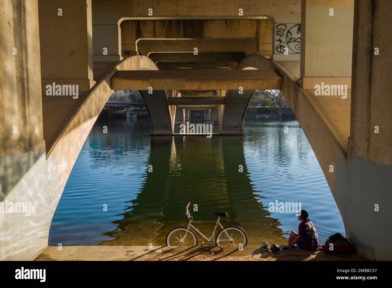 Bicycle rider takes a moment of reflection under Lamar Street Bridge ...