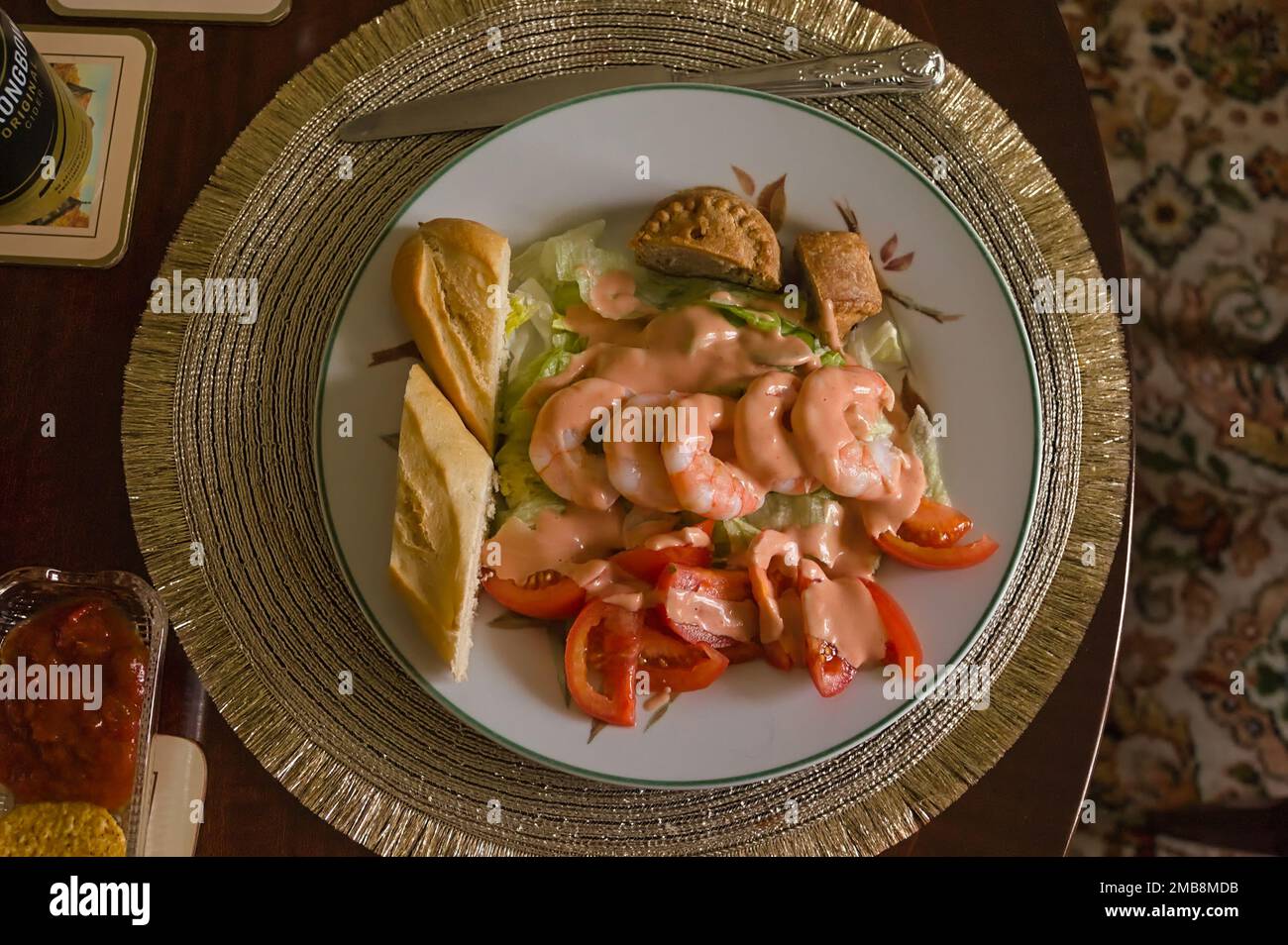 A tasty shrimp salad meal with a pork pie on a table setting Stock Photo