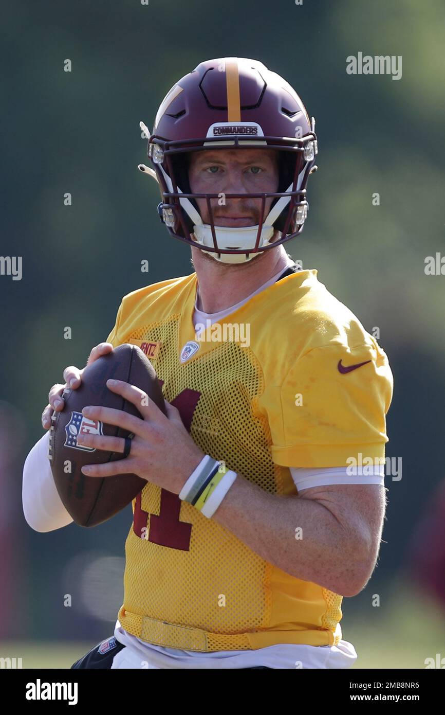 Washington Commanders quarterback Carson Wentz looks off a pass during