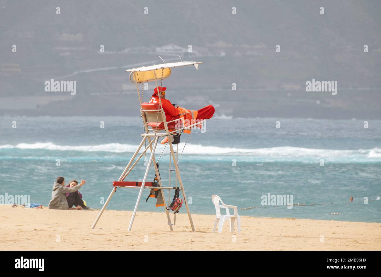 Las Palmas, Gran Canaria, Canary Islands, Spain. 20th January 2023. Cooler weather for British tourists (and lifeguards) on the city beach in Las Palmas on Gran Canaria as a cold front brings rain, strong winds, and lower temperatures to the Canary Islands. Credit: Alan Dawson/Alamy Live News Stock Photo