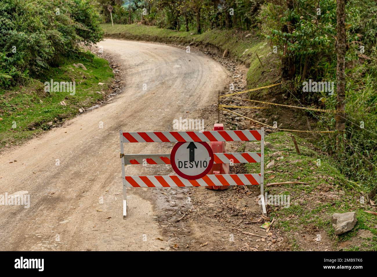 barrier with a no entry sign on a dirt road, detour written in