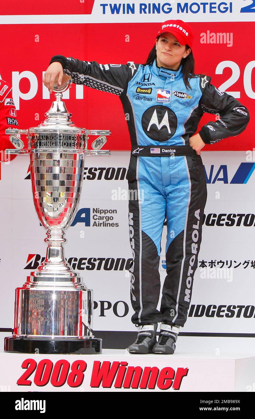 FILE - Danica Patrick of Andretti Green Racing poses with trophy on the  podium after winning the Bridgestone Indy Japan 300 mile auto race on the  1.5-mile oval track at Twin Ring