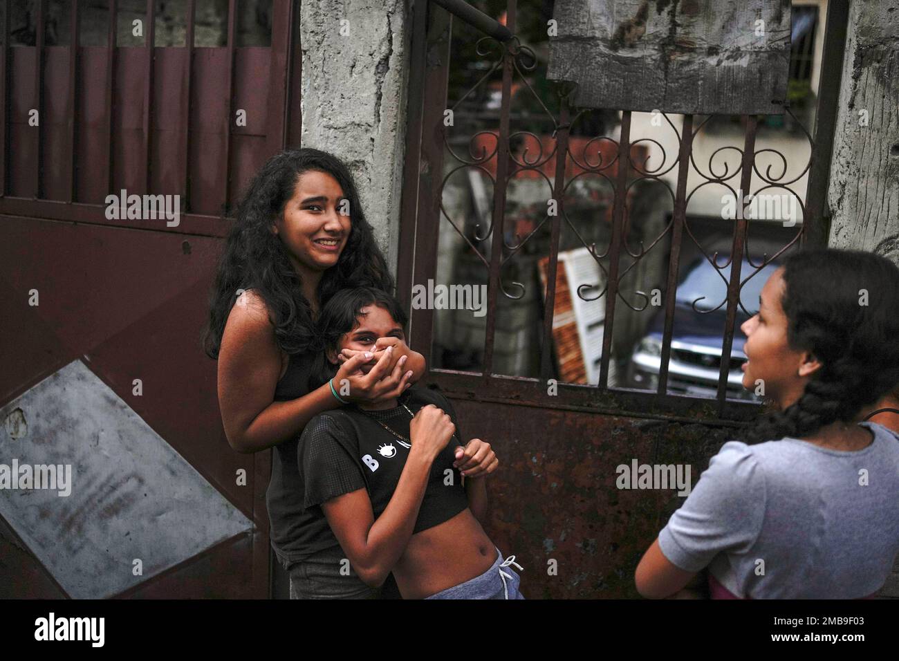 Youths plays on a street of the Petare neighborhood in Caracas ...