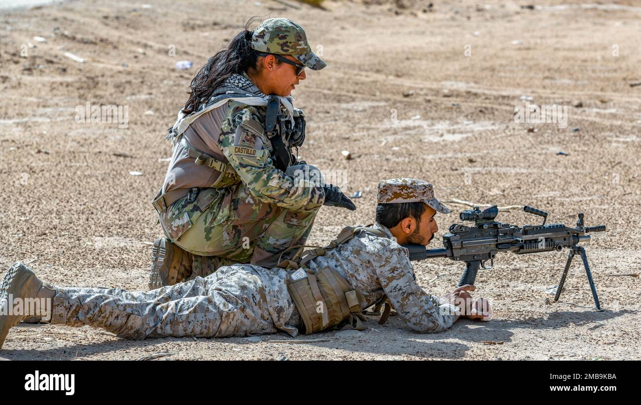 U.S. Air Force Staff Sgt. Jennifer Castillo, assigned to the 378th Expeditionary Security Forces Squadron, checks up on a Royal Saudi Land Force soldier holding security, during a training exercise in Al-Kharj, Kingdom of Saudi Arabia, June 13, 2022. Eight USAF Defenders were invited by the U.S. Army to attend Task Force Hurricane’s platoon immersion course alongside the Royal Saudi Land Force. The immersion allowed the 378th ESFS members a chance to develop as multi-capable Airmen by learning both Joint Force infantry tactics and Partner Nation infantry tactics not commonly taught or practice Stock Photo