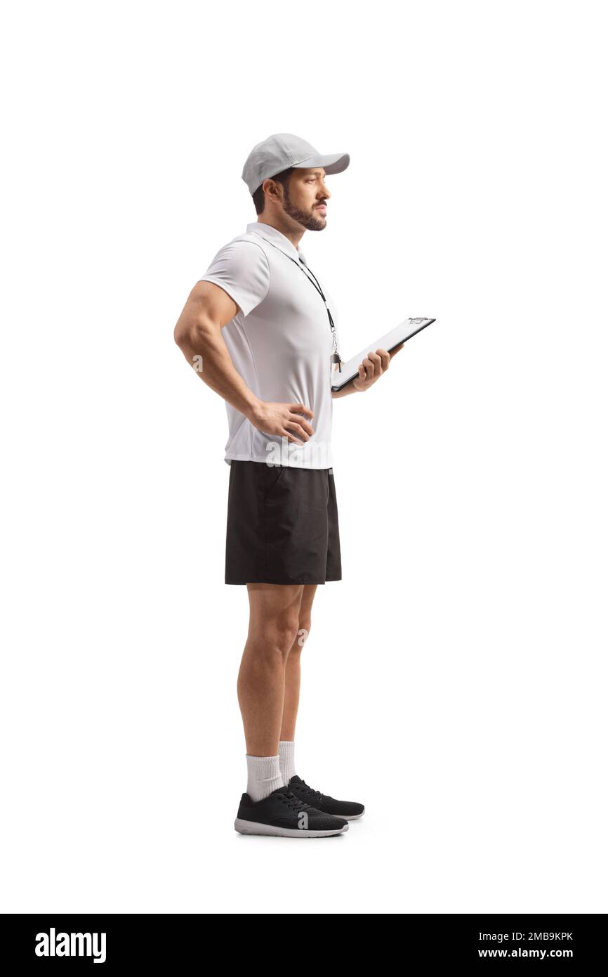 Full length profile shot of a sports coach holding a clipboard isolated