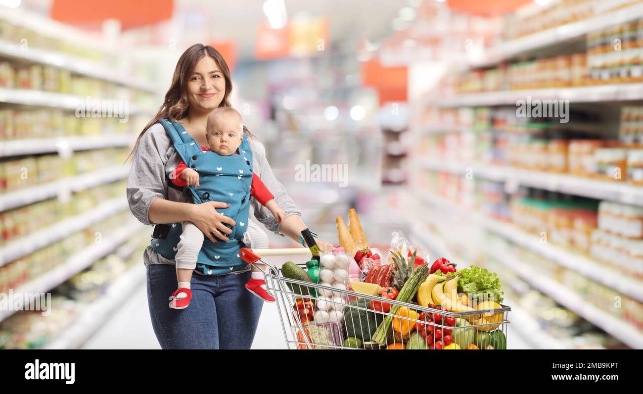 Mother with a baby shopping inside a supermarket Stock Photo Alamy