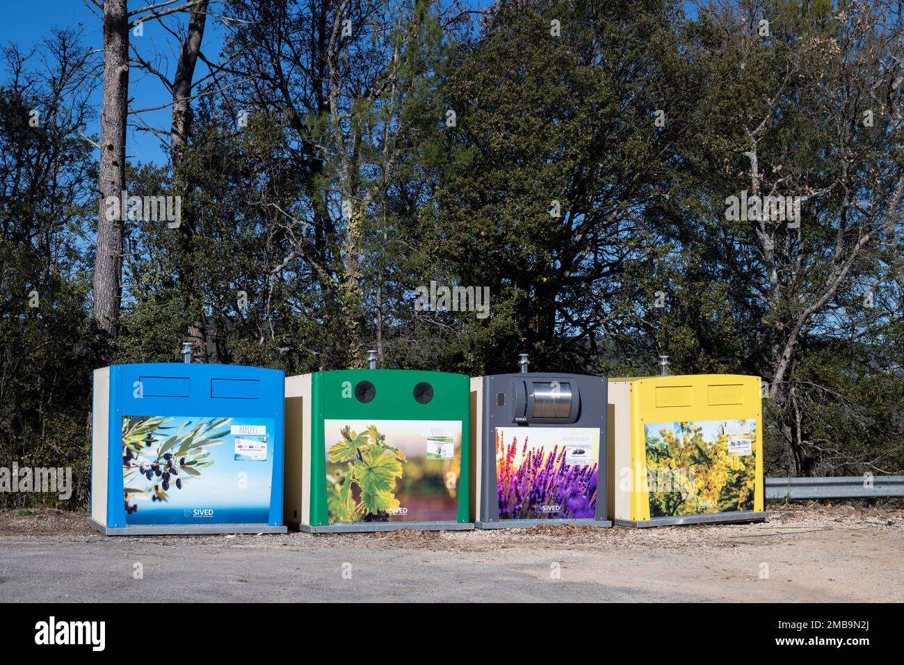 Recycling point with Color-coded garbage street containers in south of France. Colourful recycling bins, Waste sorting concept Stock Photo