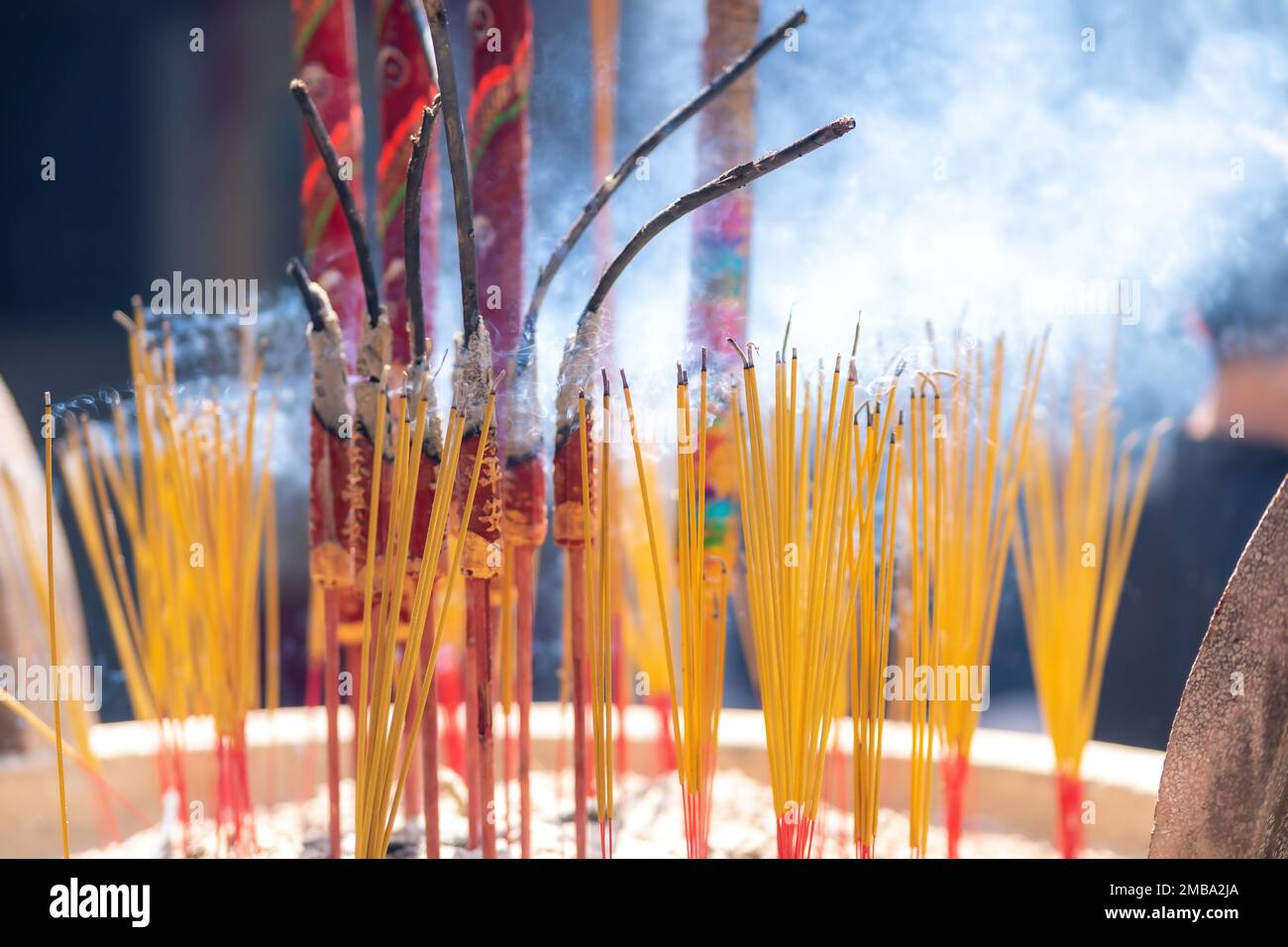 Close up of burning incense sticks on the doors of temples in Vietnam