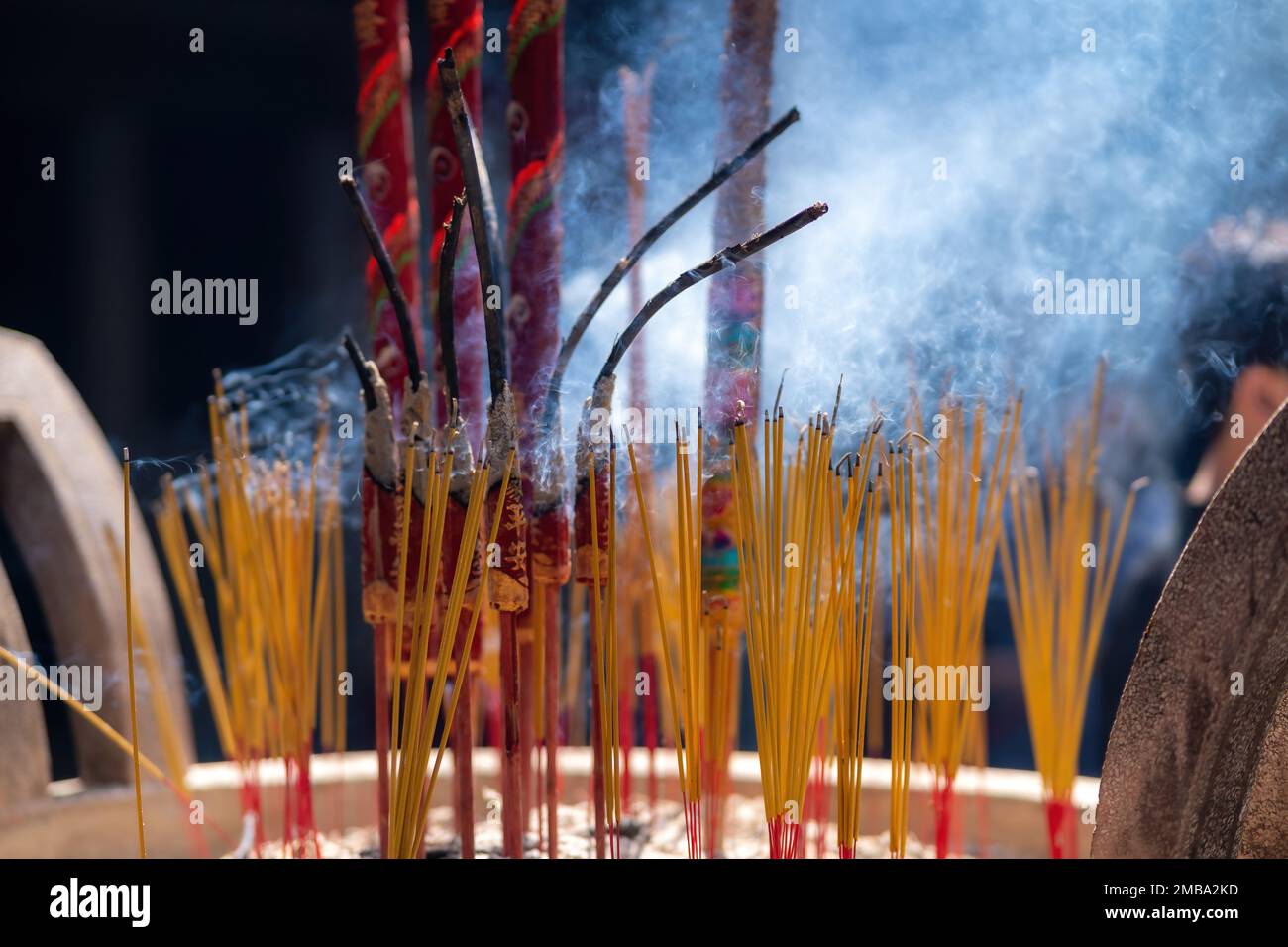 Close up of burning incense sticks on the doors of temples in Vietnam