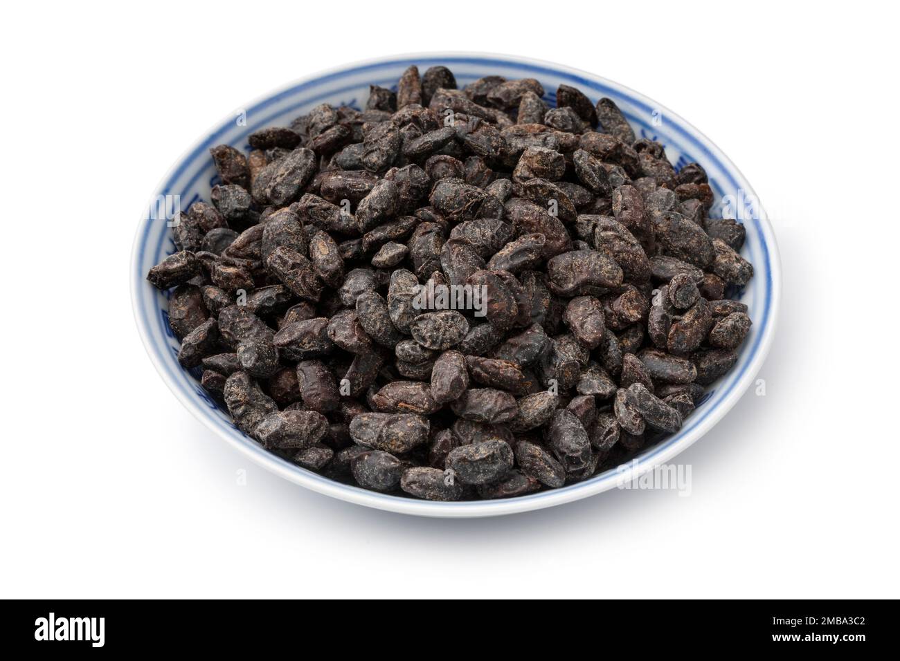 Bowl with Chinese salted black beans as an ingredient close up isolated on white background Stock Photo
