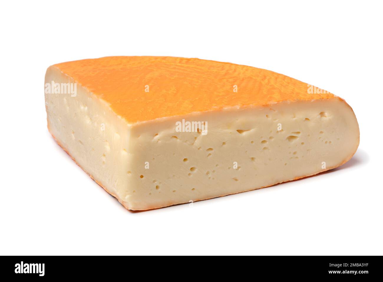 Piece of fresh Chaumes cheese close up isolated on white background Stock Photo