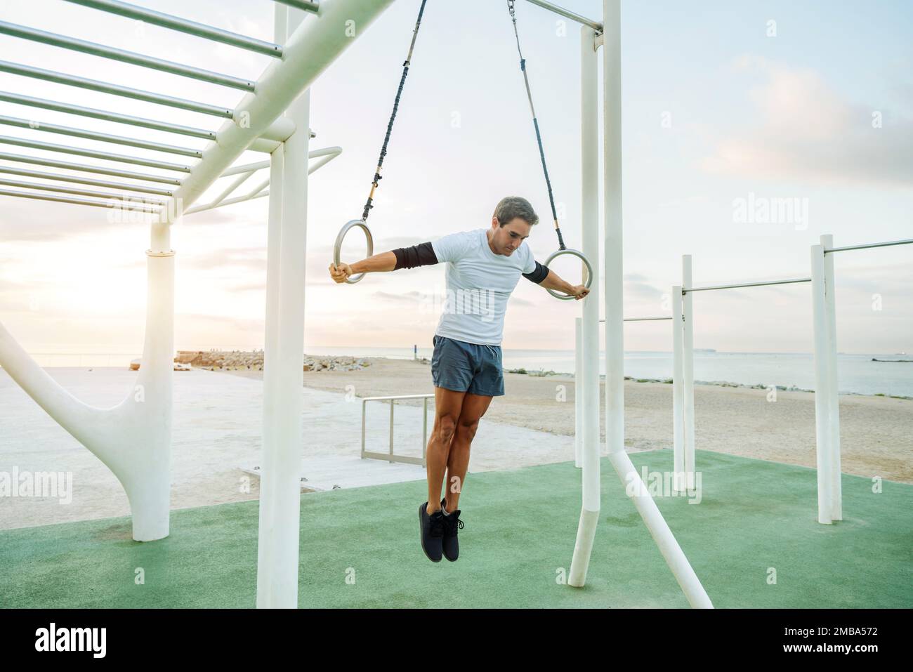 Sportive and athletic man doing functional training exercise at the outdoor gym Adult athlete doing workout at sunrise at calisthenics park on the b Stock Photo Alamy