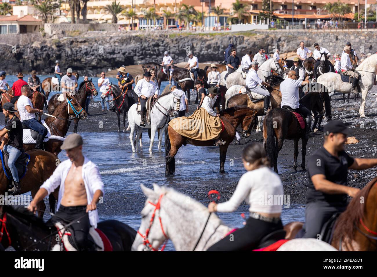 Costa Adeje, Tenerife, Canary Islands, 20 January 2023. Riders take their mounts into the sea at Playa Enramada beach during the fiesta of San Sebastian which returns for the first time since 2020 due to the covid pandemic restrictions. The annual fiesta in La Caleta on the Costa Adeje is enjoyed by locals and tourists who gather to see the many horses that come to bathe in the sea at the Playa Enramada beach. Credit: Phil Crean A/Alamy Live News Stock Photo