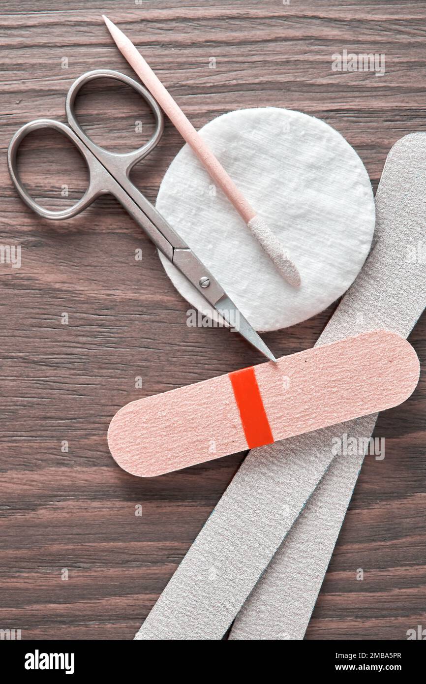 Vertical image with manicure equipment and instruments on the wooden table. Salon desk closeup view Stock Photo