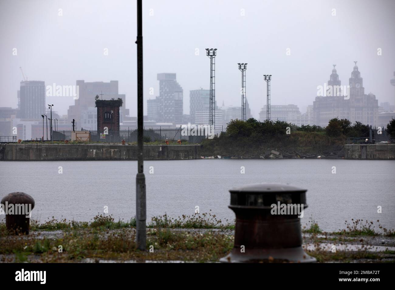 Looking across the East Float dock in Birkenhead, part of the Wirral Waters development, towards the Liver Building across the river Mersey in Liverpool. Wirral Waters will form part of the Liverpool City Region Freeport, which was announced recently by the Conservative government. Stock Photo
