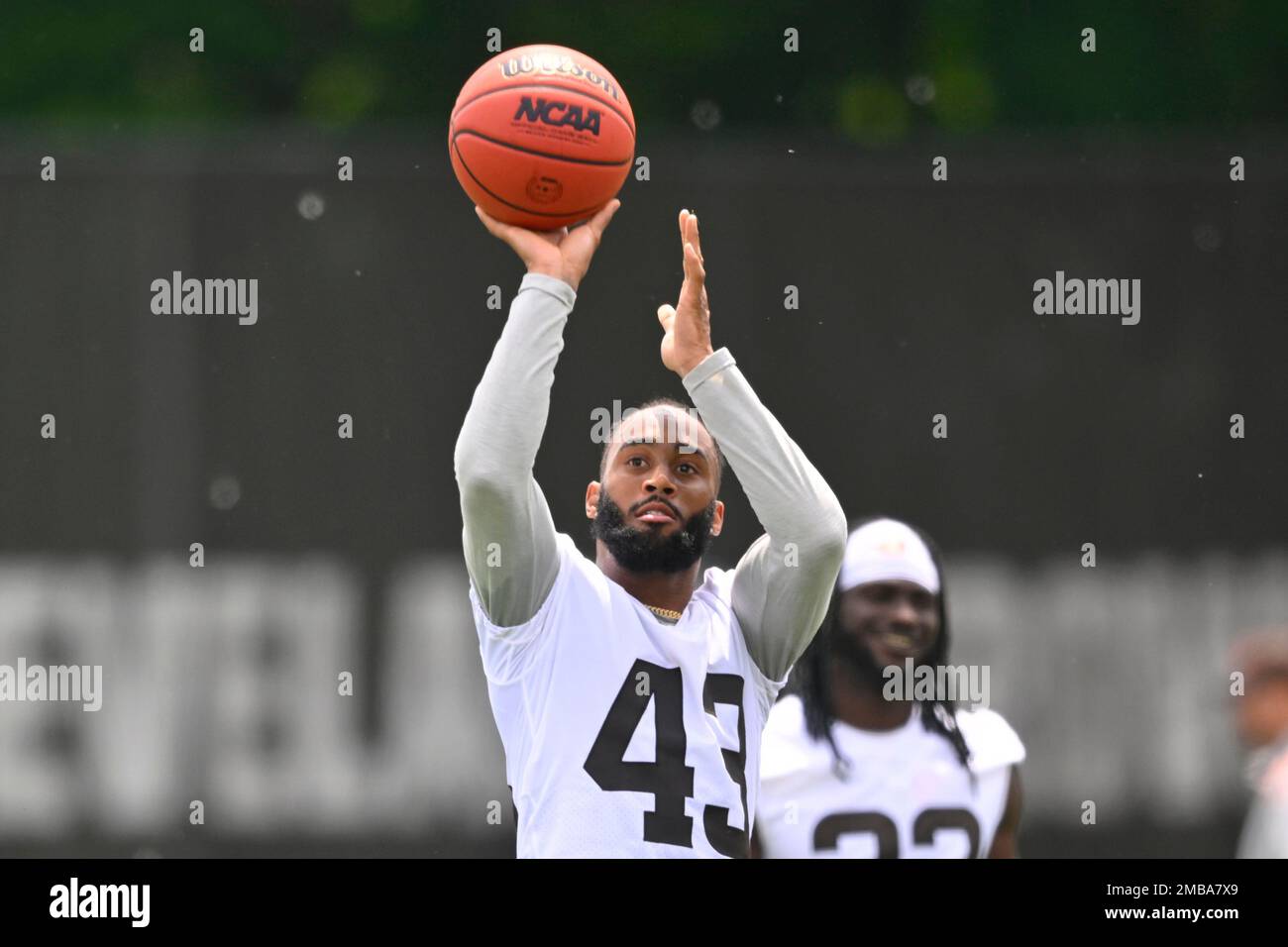 Cleveland Browns safety John Johnson III shoots a basketball after